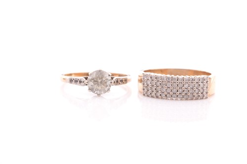 Lot 52 - A four row half hoop diamond ring; the round...