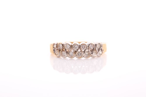 Lot 62 - A two row 18 carat gold and diamond half hoop...