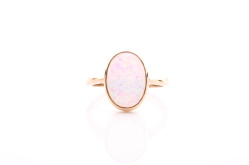 Lot 42 - A single stone opal ring, the oval opal in rub-...