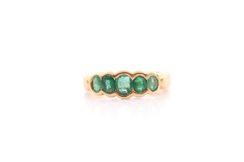 Lot 211 - A five stone half hoop emerald ring, the...