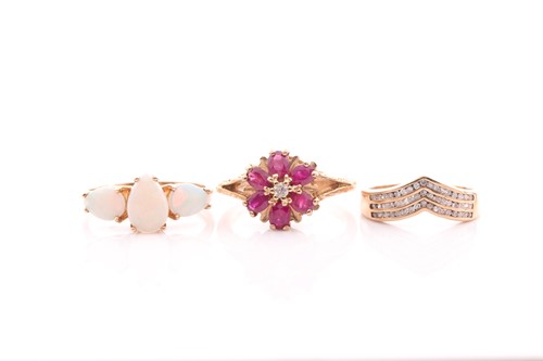 Lot 84 - A ruby and diamond cluster ring, in 9 carat...