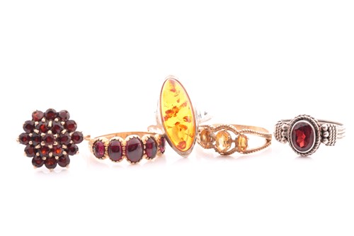 Lot 239 - A garnet cluster ring in 9 carat gold mount; a...