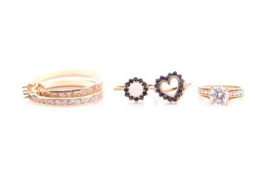 Lot 171 - A sapphire open heart ring, set with circular...