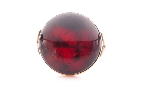 Lot 10 - A yellow metal and amber ring, set with a...
