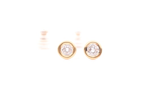 Lot 54 - A pair of yellow metal and diamond solitaire...