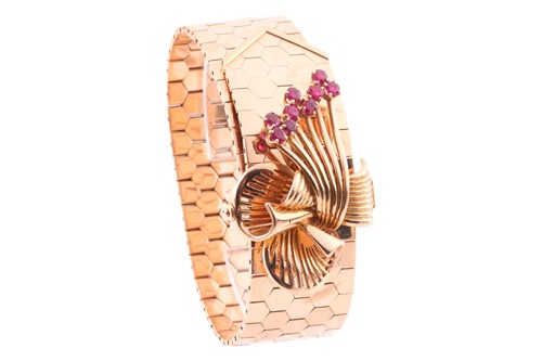 Lot 337 - A vintage gold and ruby bracelet; the flat...