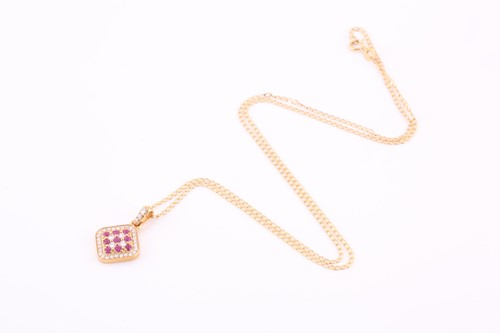 Lot 340 - An 18ct yellow gold, diamond, and ruby pendant,...