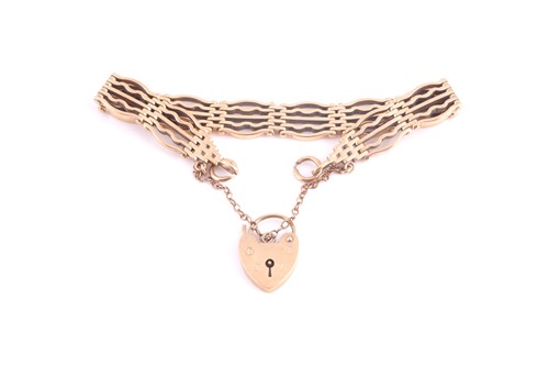 Lot 275 - A 9ct yellow gold gate-link bracelet, fastened...