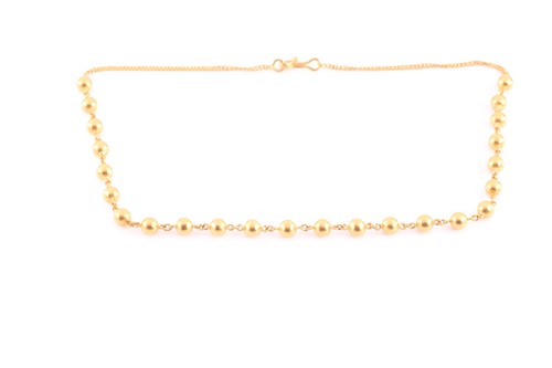 Lot 141 - A yellow metal beaded necklace, with flat-link...