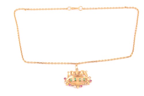 Lot 335 - An Indian yellow metal pendant, with red and...