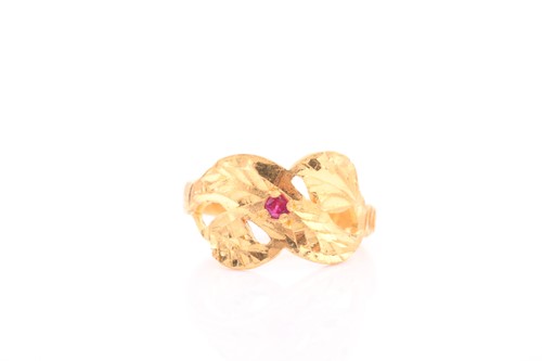 Lot 311 - An Indian yellow metal ring, with engraved...