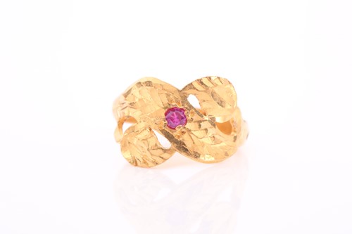 Lot 132 - An Indian yellow metal and red stone ring, the...