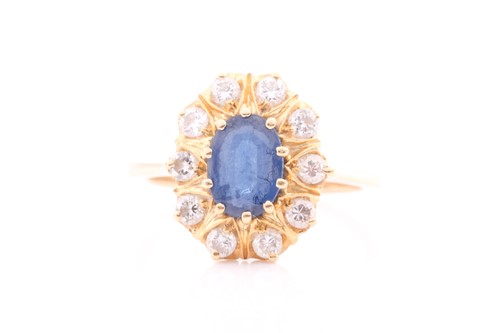 Lot 368 - A sapphire and diamond cluster ring; the oval...