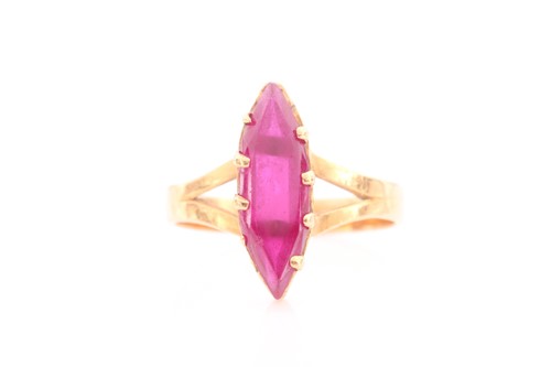 Lot 294 - A yellow metal and red paste stone ring, set...