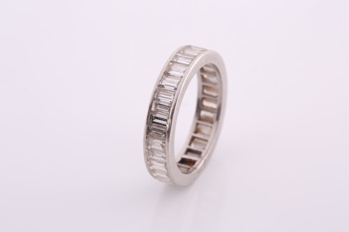 Lot 253 - A white metal and diamond eternity ring, set...