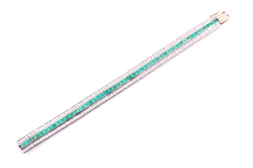 Lot 474 - An emerald and diamond line bracelet; composed...