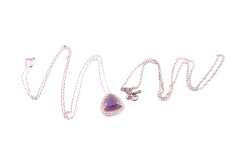 Lot 59 - An amethyst pendant and chain; the trillion...