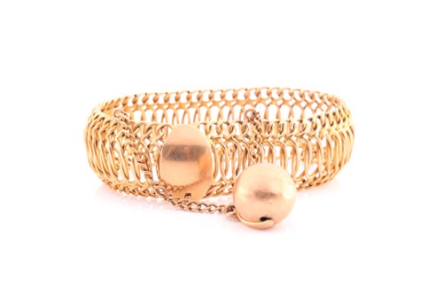 Lot 291 - A yellow metal articulated wire-link bangle...