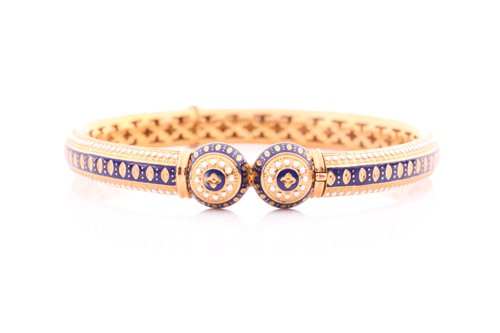 Lot 339 - A yellow metal and enamel bangle; hinged with...