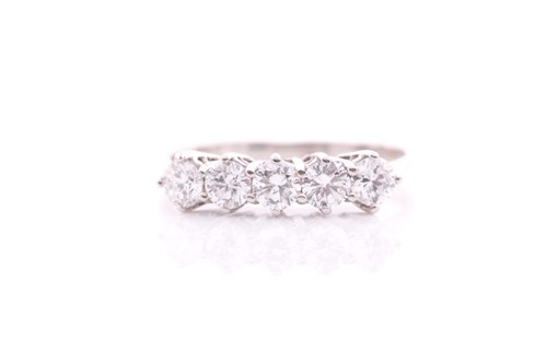 Lot 72 - A five stone half hoop diamond ring; the...