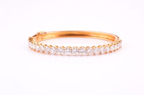 Lot 48 - A diamond bangle; the centre set with twenty...