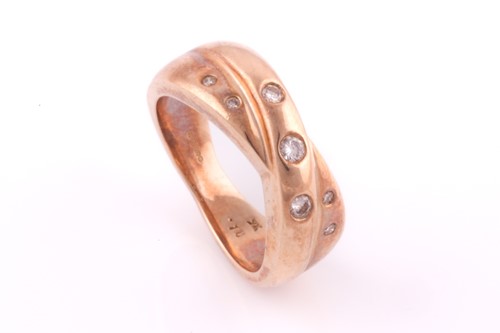 Lot 66 - A diamond crossover ring; the two polished...