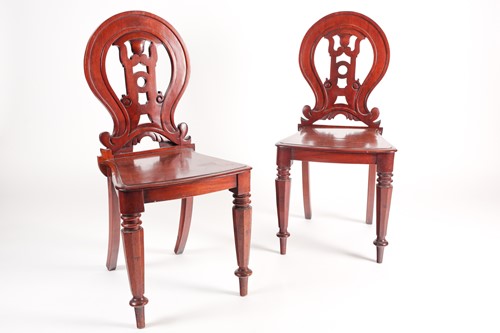 Lot 70 - A pair of Victorian mahogany hall chairs. With...