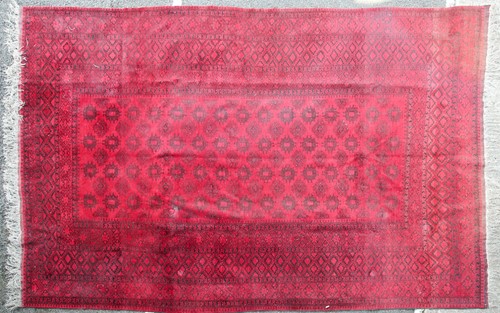 Lot 178 - A 20th-century madder red ground Afghan carpet,...