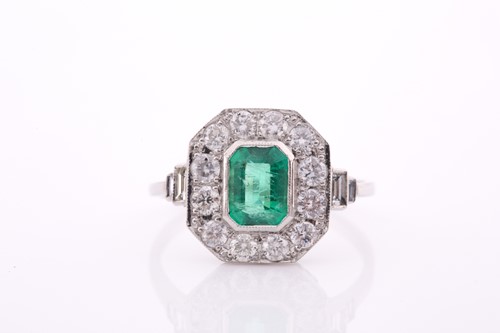 Lot 17 - A platinum, diamond, and emerald ring, set...
