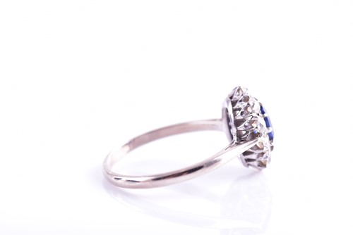 Lot 30 - A diamond and sapphire cluster ring, set with...