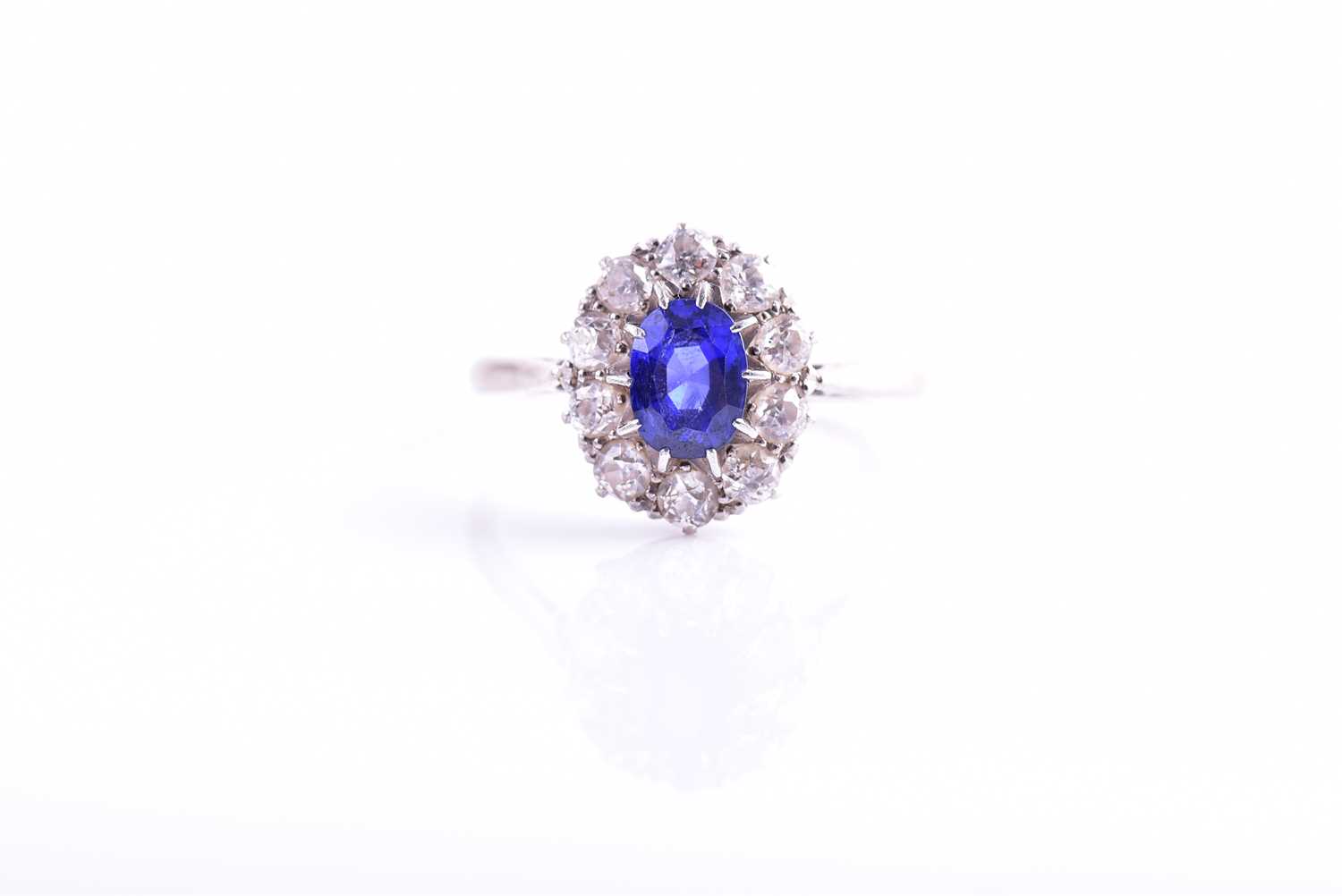 Lot 30 - A diamond and sapphire cluster ring, set with...