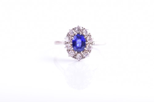 Lot 30 - A diamond and sapphire cluster ring, set with...
