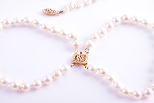 Lot 58 - A cultured pearl necklace with yellow metal...