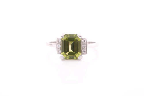 Lot 53 - A platinum, diamond, and peridot ring, set...