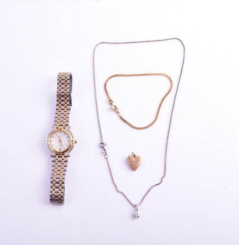 Lot 32 - A yellow metal heart-shaped pendant, together...