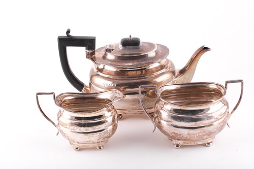 Lot 299 - A George V silver three-piece teaset,...