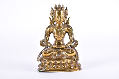 Lot 125 - A Tibetan bronze figure of Tara, Seated in the...