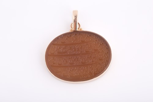 Lot 239 - An Indo Persian hardstone pendant in yellow...