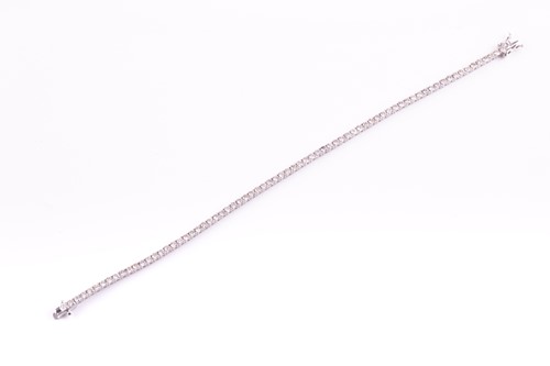 Lot 120 - An 18ct white gold and diamond line bracelet,...