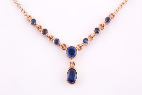 Lot 36 - A 9ct yellow gold and blue sapphire drop...