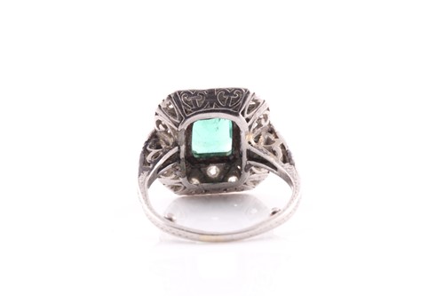 Lot 13 - An emerald and diamond dress ring, set with an...