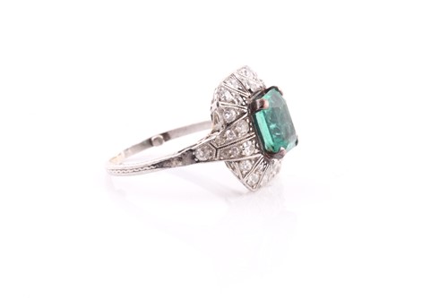 Lot 13 - An emerald and diamond dress ring, set with an...
