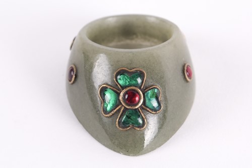 Lot 139 - An Indian moss green jade archer's ring yellow...