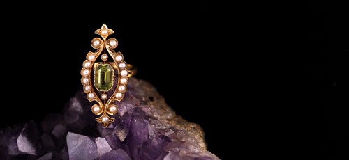 Lot 297 - An antique peridot and pearl lozenge-shaped...