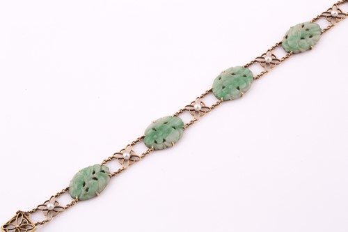 Lot 13 - A jade and seed pearl bracelet; comprising...