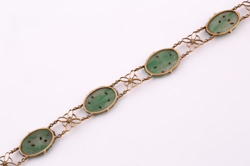 Lot 13 - A jade and seed pearl bracelet; comprising...