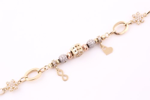 Lot 7 - A charm bracelet; the oval link chain strung...