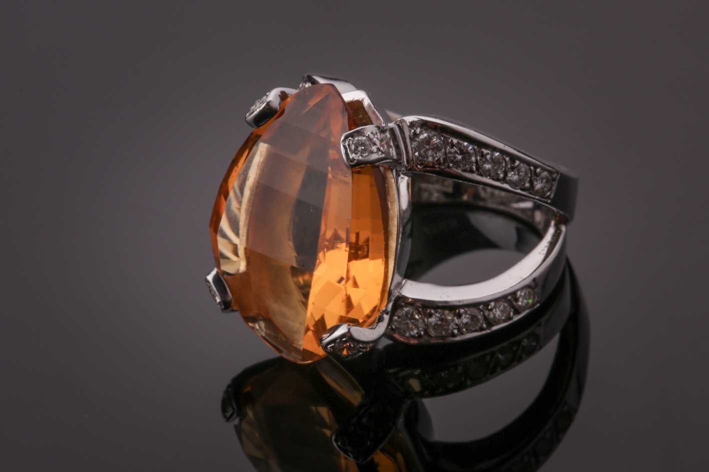 Lot 53 - A diamond and citrine cocktail ring, set with...