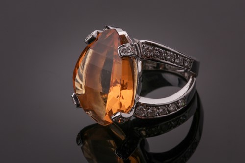 Lot 53 - A diamond and citrine cocktail ring, set with...