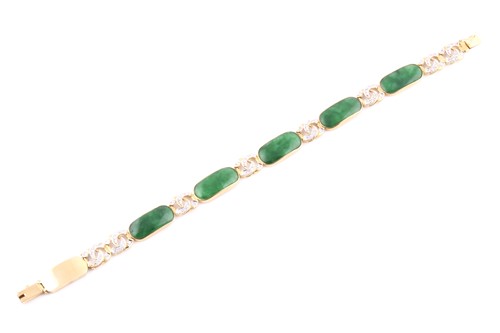 Lot 18 - An 18ct yellow gold, green jade, and diamond...